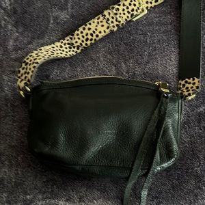 Women’s black leather handbag with adjustable cheetah strap includes dust bag